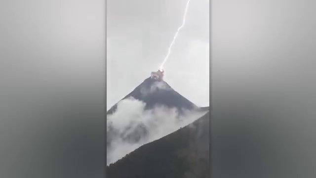 Un volcan au Guatemala crachant de la fumée traversée par des éclairs